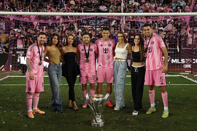 Lionel Messi #10, Antonela Roccuzzo, Romarey Ventura, Jordi Alba #18, Luis Suárez #9, Sofia Balbi, Elena Galera and Sergio Busquets #5 of Inter Miami CF celebrate with the trophy after winning the Audi 2025 MLS Cup Final match between Inter Miami CF and Vancouver Whitecaps FC at Chase Stadium on December 06, 2025 in Fort Lauderdale, Florida