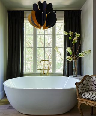 bathroom with black curtains and pendant