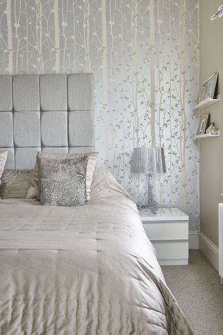 neutral bedroom with metallic tree wallpaper and silver accessories