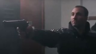 Kim Bodnia holding a pistol in Pusher