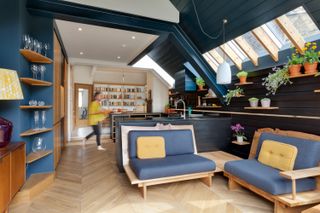 how to design an open plan kitchen: a bespoke seating area inspired by Japanese design, with a kitchen in the background