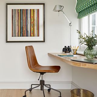study room with brown leather chair and table lamp