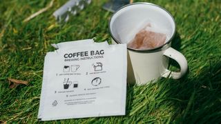 a mug of coffee with a bag in it