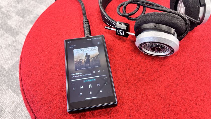 FiiO M21 portable music player plugged into a pair of Grado SR325x wired headphones