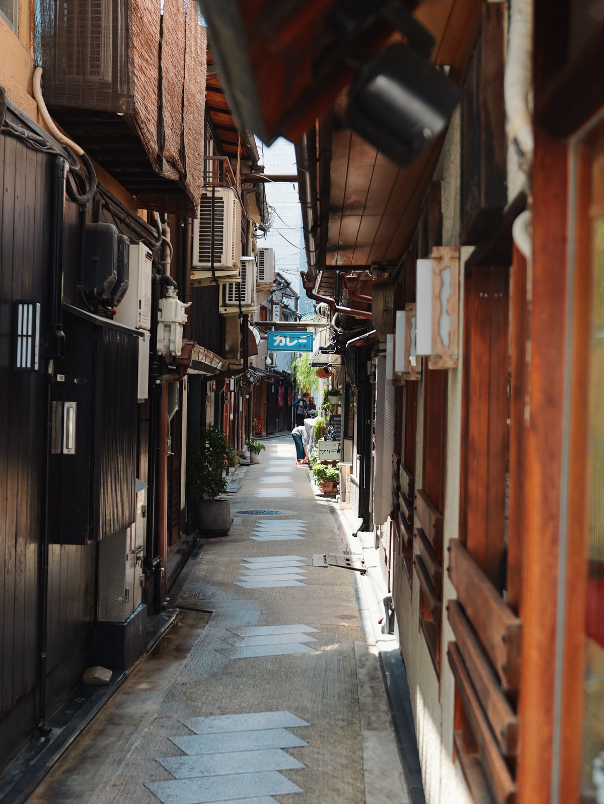 Narrow alleyway lined with traditional wooden buildings.