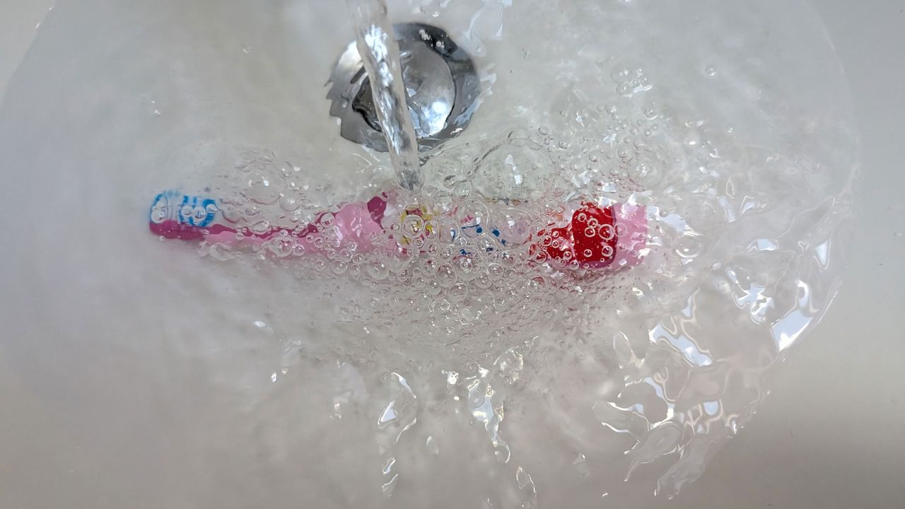 Colgate Kids Battery Powered Toothbrush being submerged underwater by our reviewer