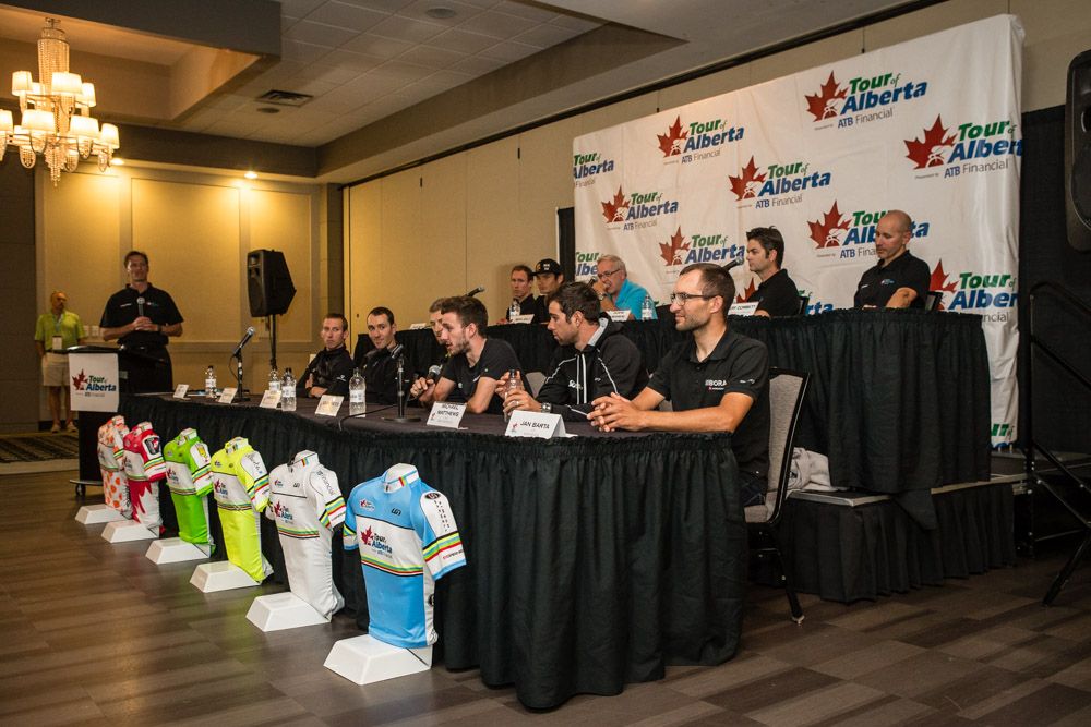 Riders and race jerseys lined up for the press conference