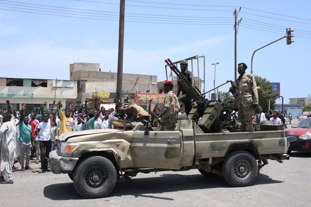 Sudanese soldiers drive through the capital of Khartoum. 