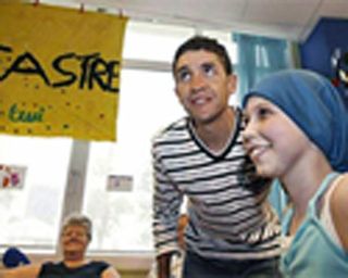 Carlos Sastre visits with some children