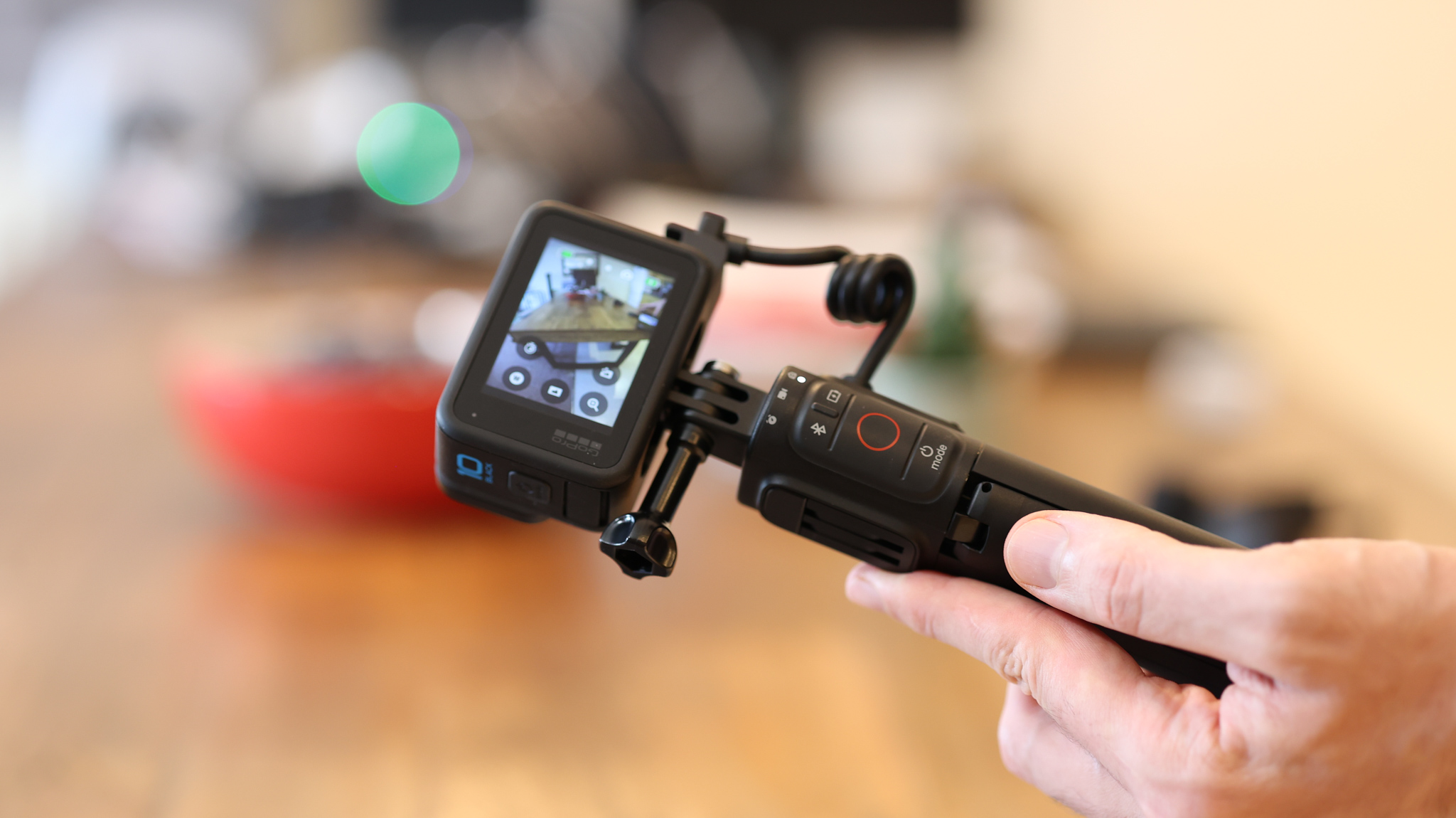 A hand holding the GoPro Volta tripod grip