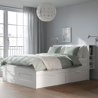 White bed frame with extra storage in headboard