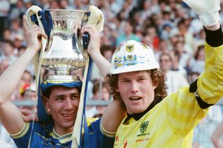 Wimbledon goalscorer Lawrie Sanchez, with the FA Cup on his head, and goalkeeper Dave Beasant, wearing a hard hat, celebrate after victory over Liverpool in the 1988 final