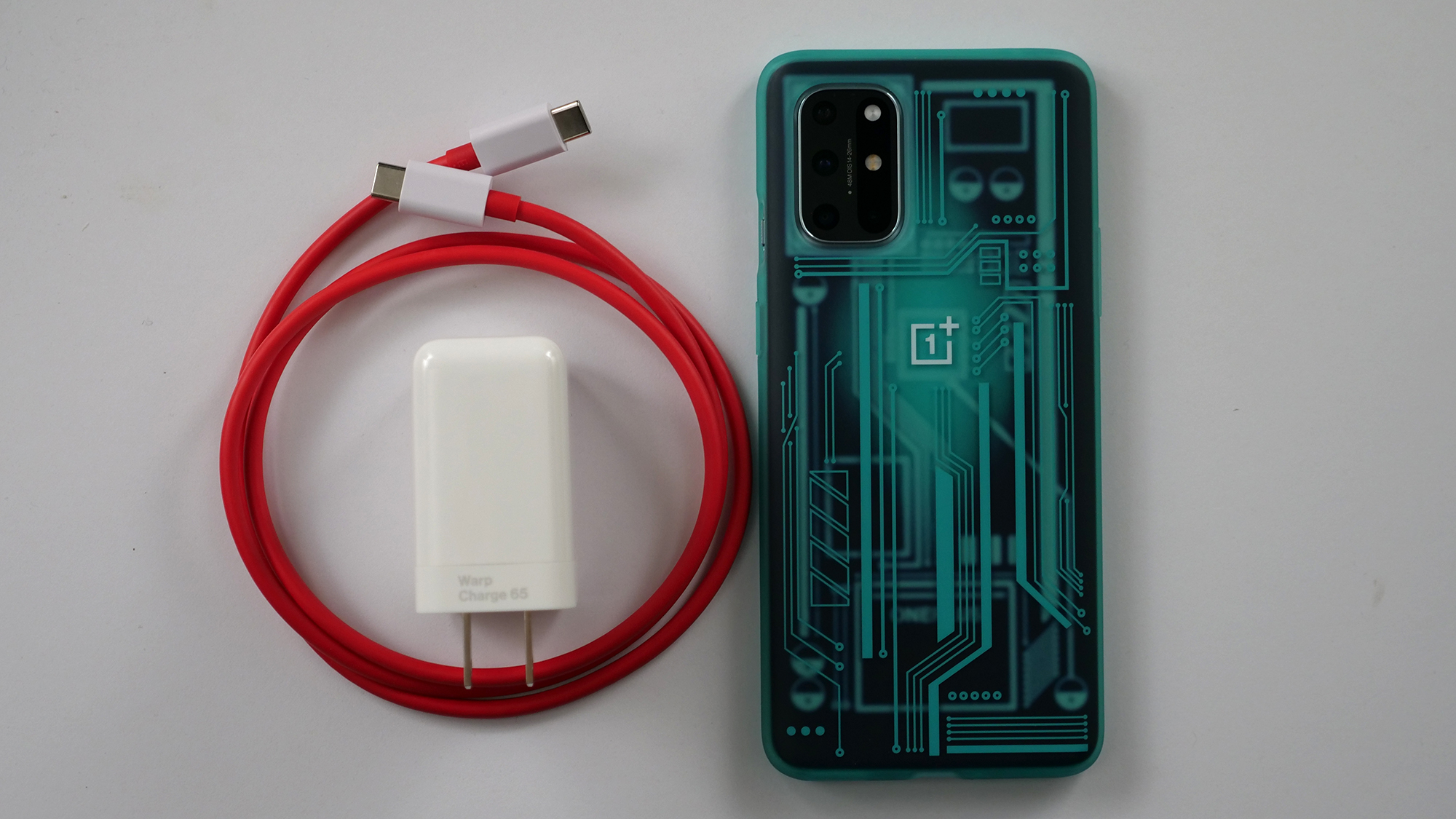 OnePlus WarpCharger 65W next to the OnePlus 8T