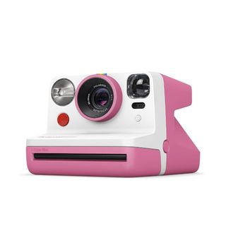 A white and pink polaroid camera