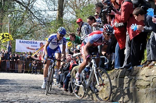 Gilbert powers to the Muur's top with Boonen behind.