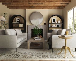 Living room with two neutral sofas facing across light wood coffee table, rug, fireplace, mirror above and shelving with decorative accessories either side