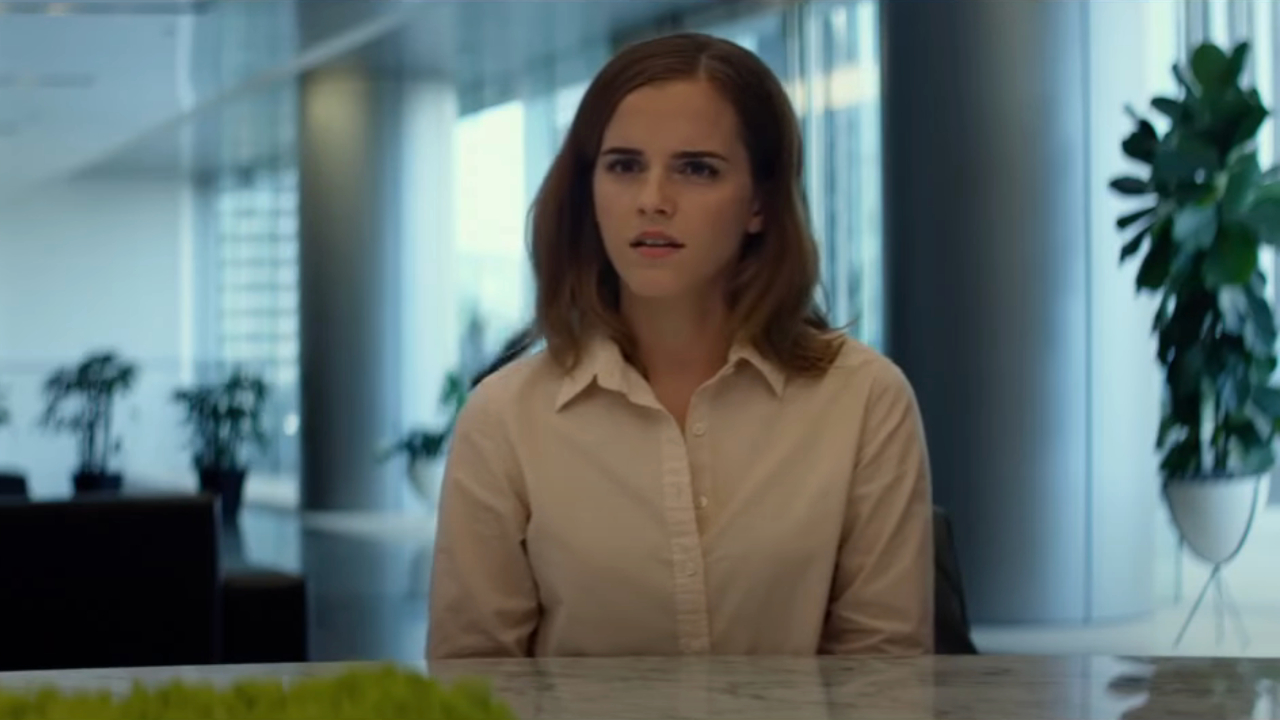 Emma Watson sits at a conference table in mid explanation in The Circle.