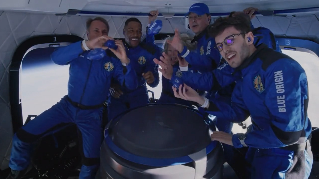 Michael Strahan and his fellow passengers on Blue Origin's New Shepard NS-19 suborbital spaceflight pose for a crew photo while in space during their Dec. 11, 2021 launch.