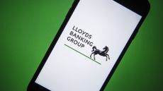 Lloyds Banking Group branding and black horse logo pictured on a smartphone screen.