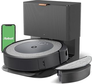 The iRobot Roomba Combo i5 Plus sits angled slightly to the left, with a smart phone slightly behind and to the left with iRobot written in white on a green background.