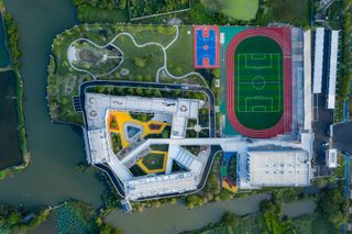 An aerial view of school buildings and sports fields.
