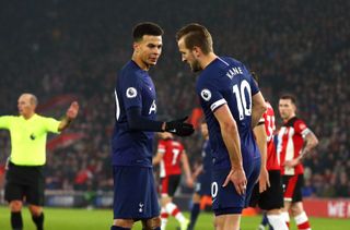 Harry Kane, right, holds his hamstring after suffering an injury in a match against Southampton