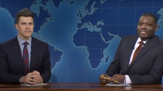 Colin Jost and Michael Che behind the Weekend Update desk on SNL