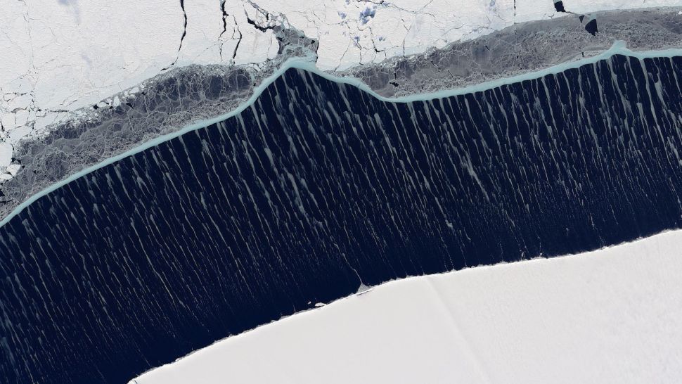 Rare wispy ice formations streak across the sea near Antarctica in beautiful sat..