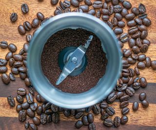 a coffee blade grinder with coffee beans and grounds inside