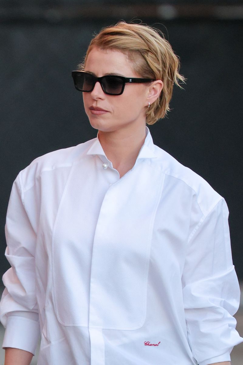 Jessie Buckley is seen on January 15, 2026 in Los Angeles, California, with a pixie cut hairstyle and wearing black sunglasses and a white shirt.