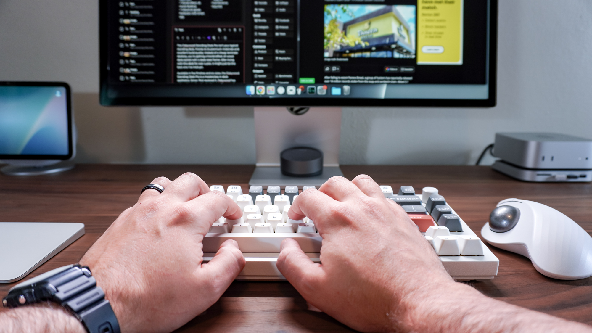 A person typing on the Keychron Q1 Ultra 8K at a Mac-powered desk setup