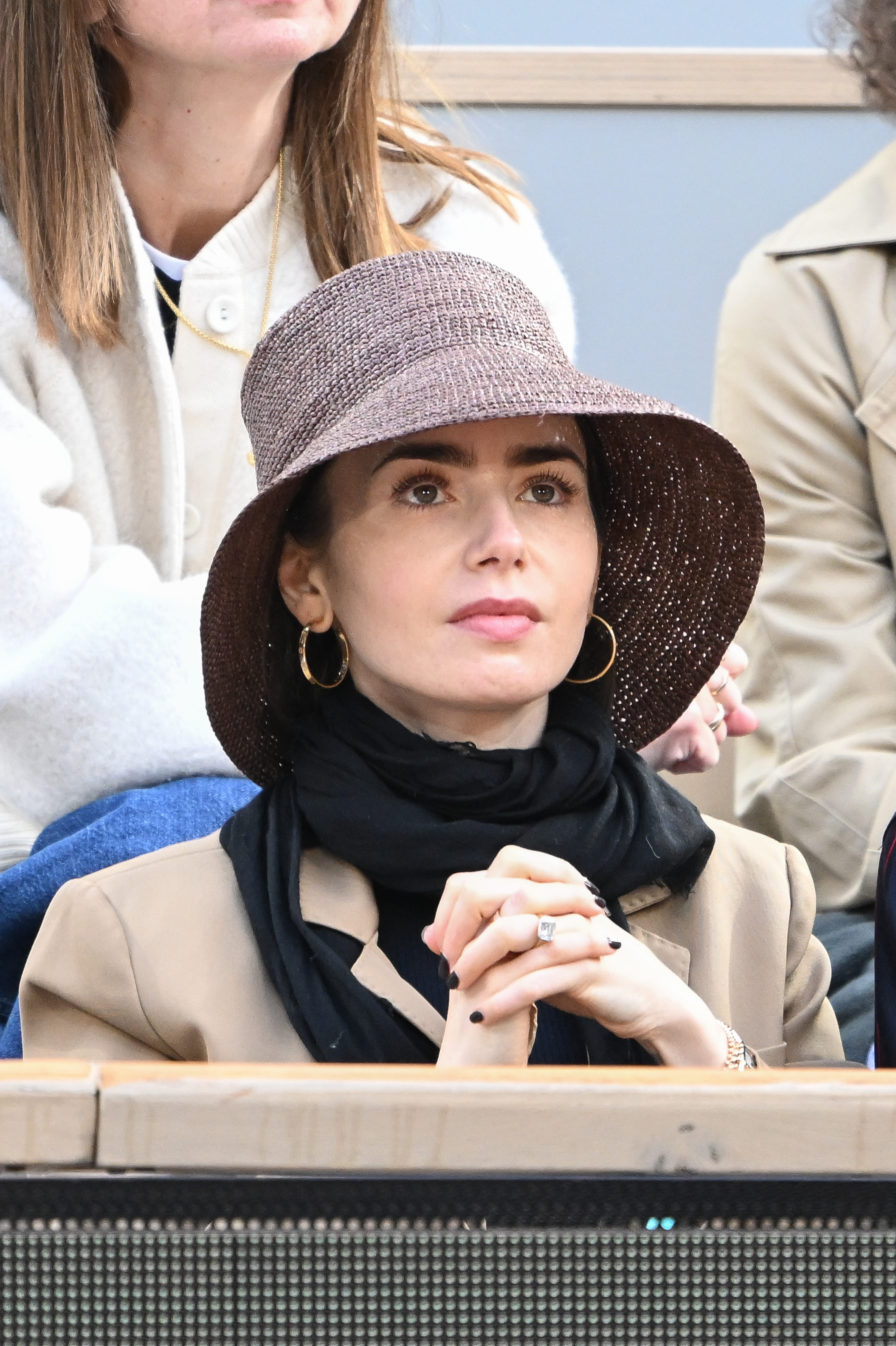 Lily Collins wears a straw summer hat to the French Open.