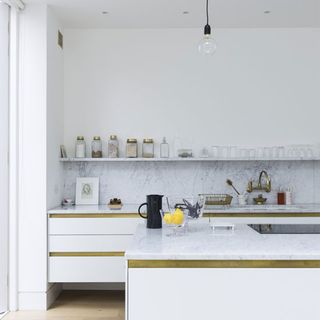 kitchen with marble and unlacquered brass