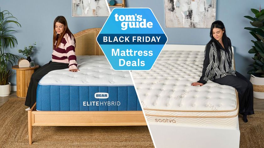 A split image of our mattress tester sitting on the left side of the navy and white Bear Elite Hybrid mattress on a wooden bedframe with a rattan headboard in a sleep studio with blue wall and a wooden round bedside table, on top of which there&#039;s the Hatch sunrise alarm clock and a plant (left). Tom&#039;s Guide mattress tester sits on the right side of the white Saatva Classic mattress with gold detailing on a white bedframe in sleep studio with a blue wall and bedside plant (right). A Tom&#039;s Guide Black Friday mattress deals badge is overlaid.