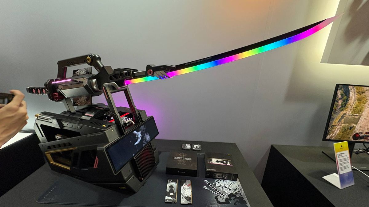 An RGB samurai sword on a pedestal that is actually a PC. The words 'Shugo' can be seen on the wall behind the exhibition piece from Corsair.