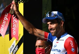 GroupamaFDJ teams French rider Thibaut Pinot celebrates winning the combativity prize on the podium after the 9th stage of the 109th edition of the Tour de France cycling race 1929 km between Aigle in Switzerland and Chatel Les Portes du Soleil in the French Alps on July 10 2022 Photo by AnneChristine POUJOULAT AFP Photo by ANNECHRISTINE POUJOULATAFP via Getty Images