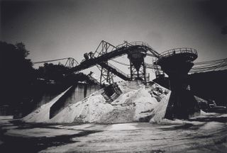 Black and white photo of outdoor mineral processing plant.