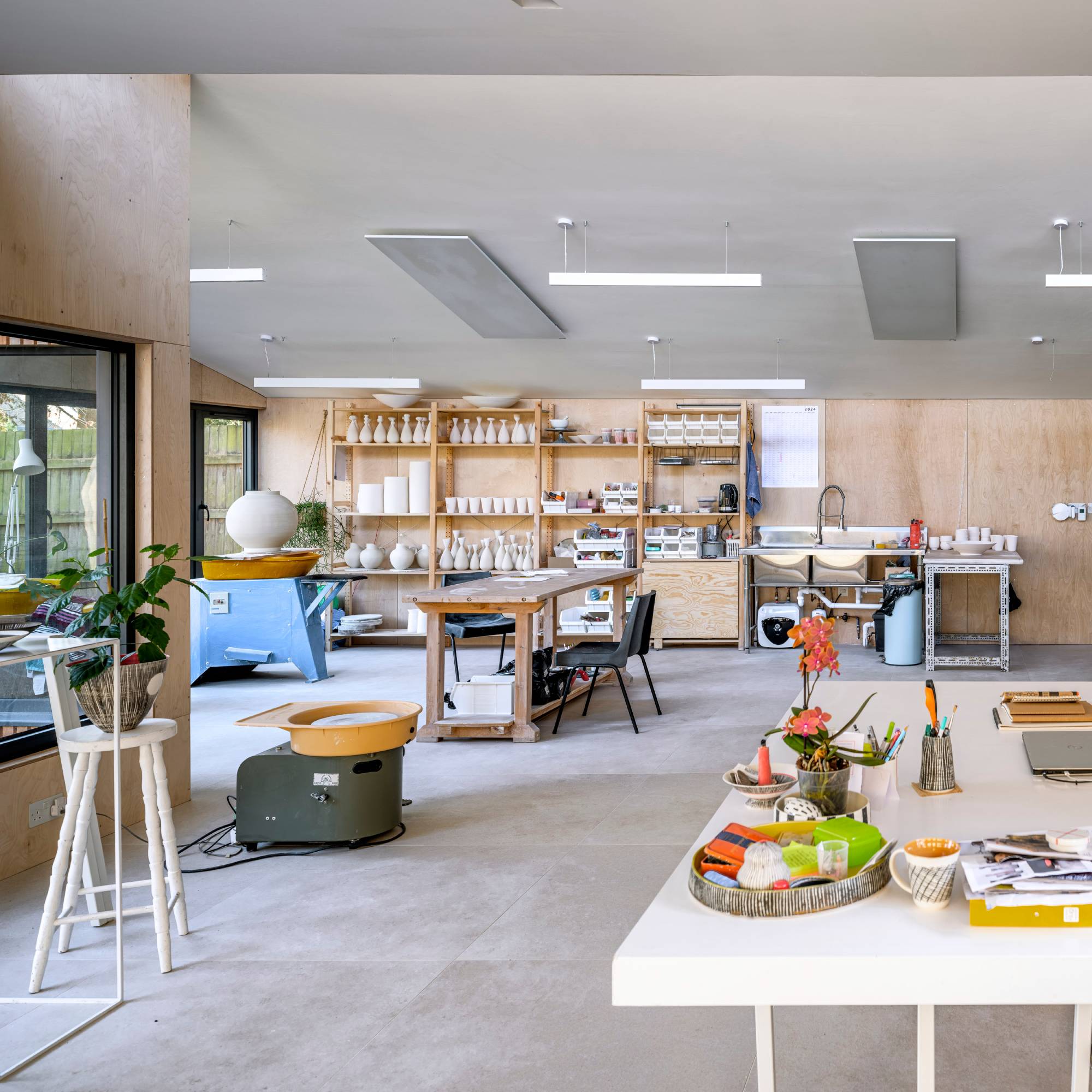 wood-clad pottery studio in garden annexe