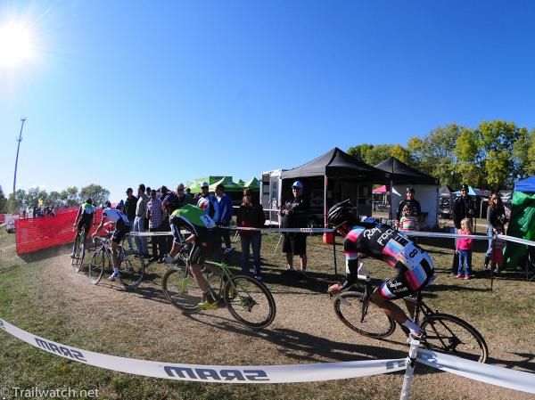 The lead riders pass by the pits