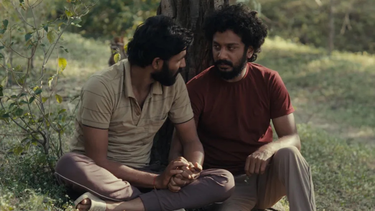 Bhushaan Manoj as Anand and Suraaj Suman as Balya sitting side by side in front of a tree in Cactus Pears