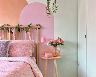 @homewithhelenandco green and pink floral bedroom with a plant hanging above