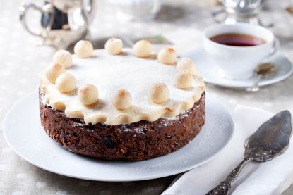 Homemade Simnel cake on a plate with a cutting knife