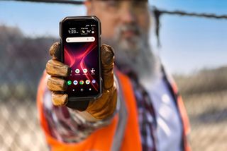 Kyocera DuraForce Pro 3 product shot, being held by a construction worker