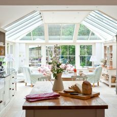 Spacious and bright kitchen conservatory with table and sofa seating