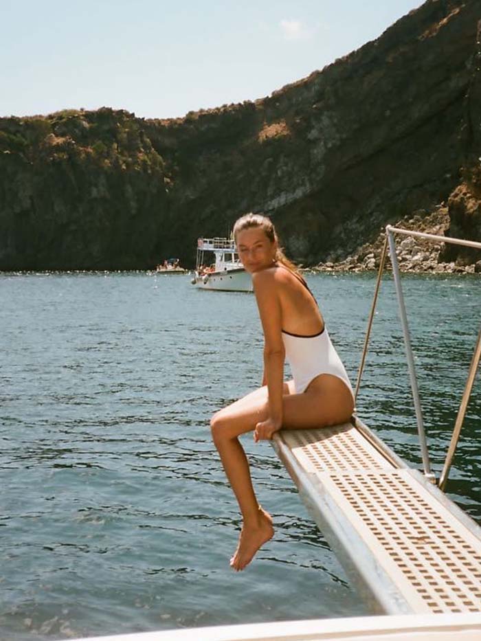 Camille Charriere wearing a one-piece swimsuit.