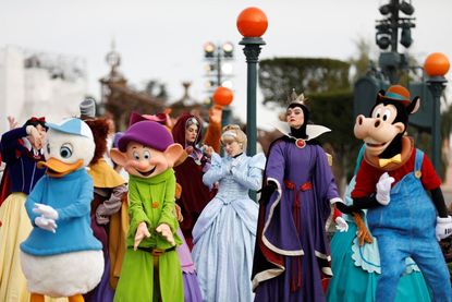 Disney cast members Dewey L Cinderella C and Evil Queen R take part in a parade during a ceremony marking the 100th anniversary of the Walt Disney Company held at Disneyland Paris in MarnelaVallee east of Paris on October 16 2023 The Walt Disney Company celebrates its 100th anniversary on October 16 marking the occasion with the release of a short film featuring more than 500 characters from 85 films Disneyland Paris marked that anniversary with an parade showcasing a hundred of Disneys characters Photo by Ian LANGSDON AFP Photo by IAN LANGSDONAFP via Getty Images