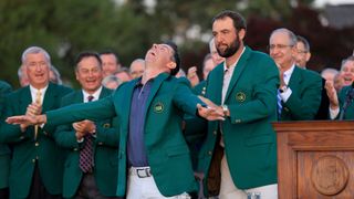 Rory McIlroy receiving his Green Jacket from Scottie Scheffler at the 2025 Masters