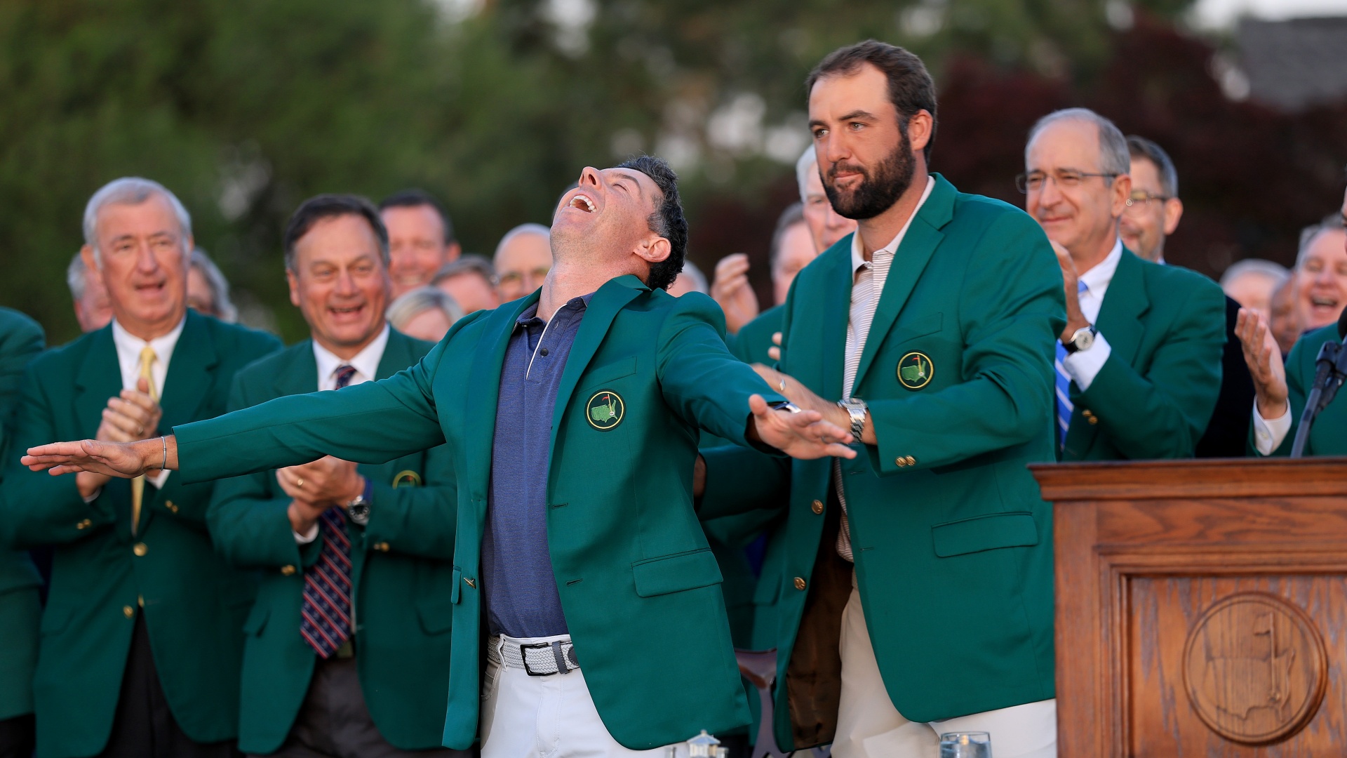 Rory McIlroy receiving his Green Jacket from Scottie Scheffler at the 2025 Masters