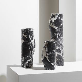 Vases in white veined black marble