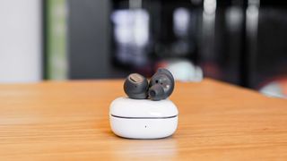 Samsung Galaxy Buds FE wireless earbuds held in the hand.